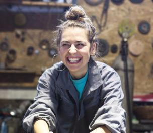 happy young woman working in a workshop